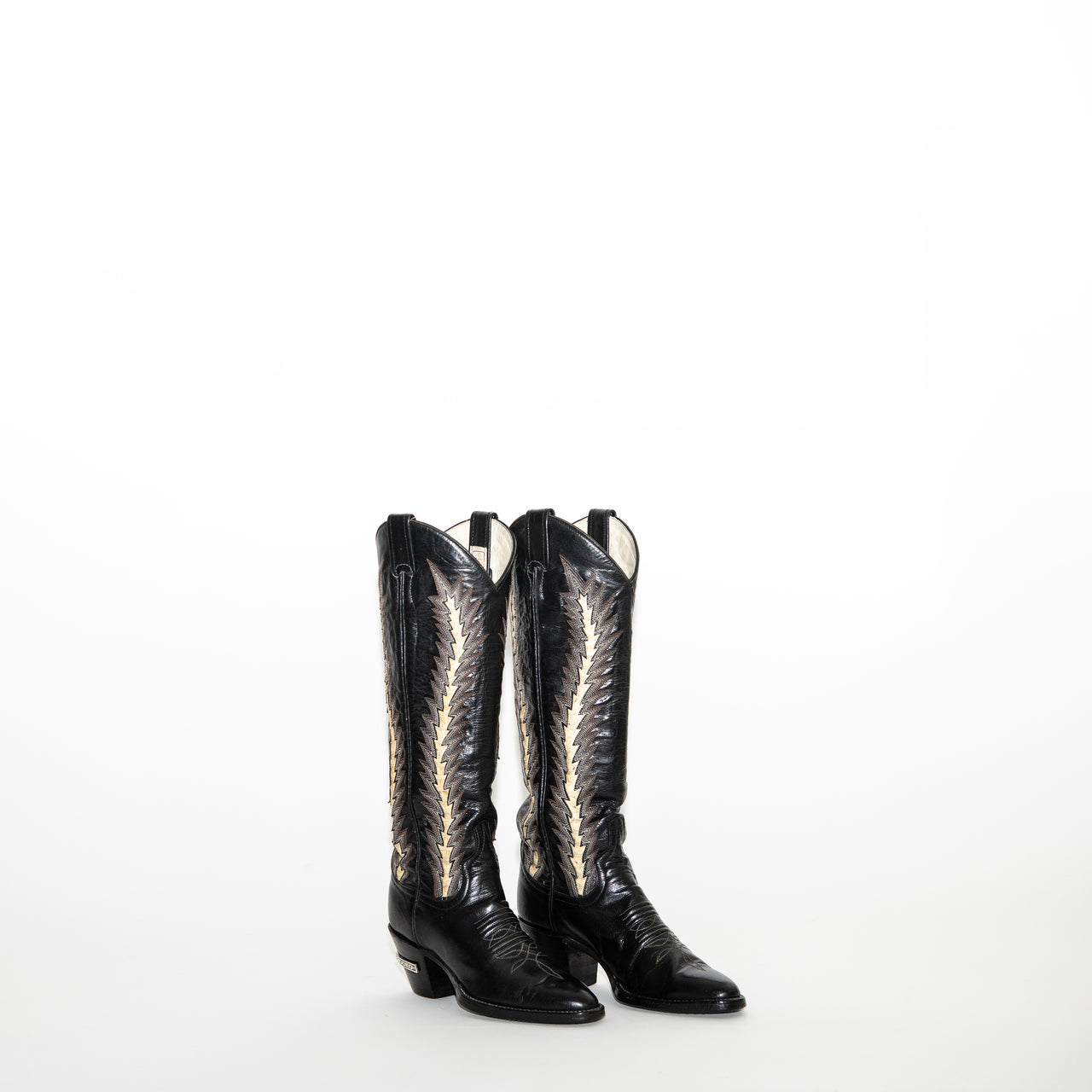 black, white, and tan star-stitched snake-skin boot